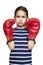 Young girl wearing boxing gloves sad and upset