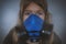 Young girl wearing gasmask, respirator portrait