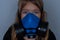 Young girl wearing gasmask, respirator portrait