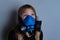 Young girl wearing gasmask, respirator portrait