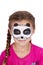 Young girl wearing panda carnival face paint