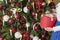 A young girl wears a tree. Girl in formal. The process of preparation for the celebration of New Year and Christmas