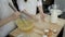 Young girl whipping eggs in glass bowl at wooden table