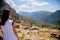 Young girl in white clothes standing on rock in Greece