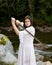 Young girl in white dress with two handed sword