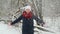 Young girl in white knitted hat, red scarf and mittens