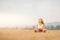 Young girl in white shirt, sportswear with long hair Blonde meditates yoga in field sunrise. Relaxation concept
