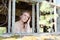 Young girl at the window. Girl in the window of an abandoned house. Portrait girl