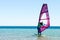 Young girl windsurfer beginner learns to ride in the sea in Egypt Dahab South Sinai