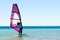 Young girl windsurfer beginner learns to ride in the sea in Egypt Dahab South Sinai