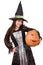 Young girl in witch costume with big pumpkin in hand