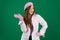 young girl woman with a pink beret on her head France fashion on a green background chromakey. different emotions pink