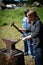 Young girl working as a blacksmith