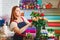 Young girl working in a flower shop, Florist woman makes a bouquet