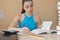 Young Girl working on his homework. Portrait of pretty girl high school student studying and writing