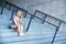 Young girl working with mobile phone and sitting on stairs