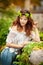 Young girl with wreath of green leaves, outdoors shot. Portrait of beautiful woman with long hair and lave white blouse