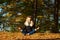 Young girl in a wreath of leaves. The girl in the park. Autumn.