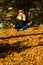 Young girl in a wreath of leaves. The girl in the park. Autumn.