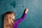 Young girl writing numbers on chalkboard