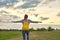 Young girl with yellow backpack, her back with open hands