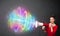 Young girl yells into a loudspeaker and colorful energy beam com