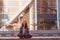 young girl yoga and meditates in the lotus position in a big city