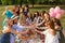 Young girls cheers on picnic party at nature