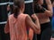 Young Girls doing Fitness and Boxing Workout with Black Punching Bag.