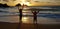 young girls doing yoga at a sunset cornish beach