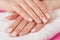 Young girls hands with cream color nails polish on fingers