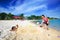 Young girls having fun playing sand mermaid