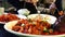 Young girls lunch in an Asian restaurant. Close-up Carp squirrel, hot shrimp.