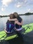 Young girls paddle boarding.