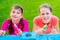 Young Girls Painting Cardboard House