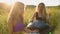 Young girls play and sing on the musical instrument Handpan. Practice meditation at sunset