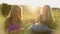 Young girls play and sing on the musical instrument Handpan. Practice meditation at sunset