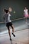 Young girls playing tennis game indoor