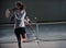 Young girls playing tennis game indoor