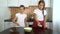 Young girls preparing working surface for dough kneading spreading flour on dark table in kitchen