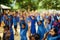 Young girls raising their hands in an assembly