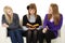 Young girls read fiction on couch