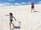 Young girls running down on Lancelinsand dunes Western Australia