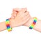 Young girls shaking hands with a bracelet patterned as the rainbow flag. isolated on white background