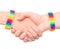 Young girls shaking hands with a bracelet patterned as the rainbow flag. on white