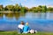 Young girls sitting at Park Novodevichy Pond looking at Moscow City skyscrapers in Moscow in Russia