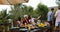 Young Girls Sitting At Table Taking selfie Photo While Men Group Cooking Barbecue Friends Gathering On Summer Terrace