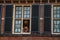 Young girls at window in the Binnenhof Gothic public buildings at The Hague.