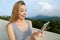 Young gladden woman using tablet in mountains background.