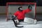 Young goalkeeper catching a puck